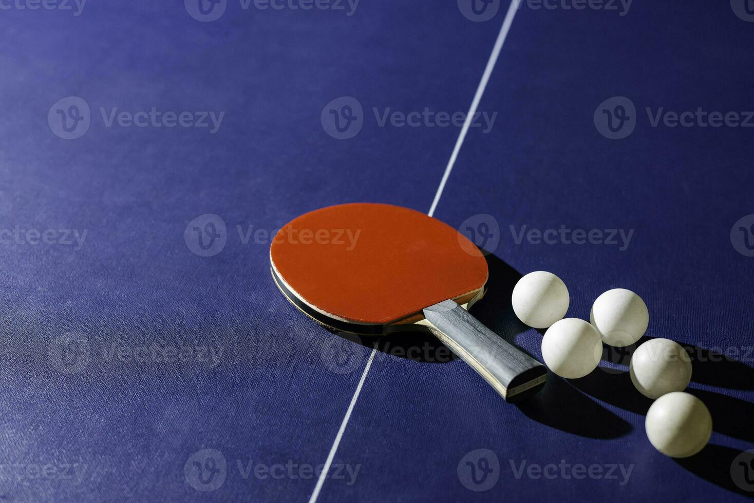 table tennis racket On the blue ping pong table photo