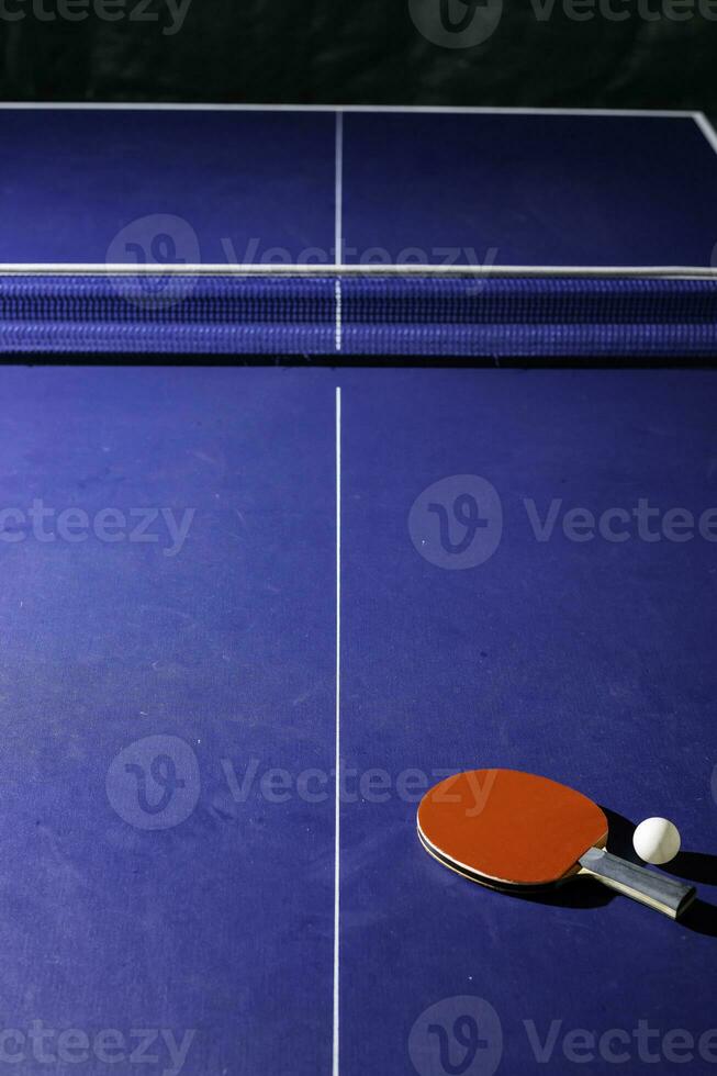 table tennis racket On the blue ping pong table photo