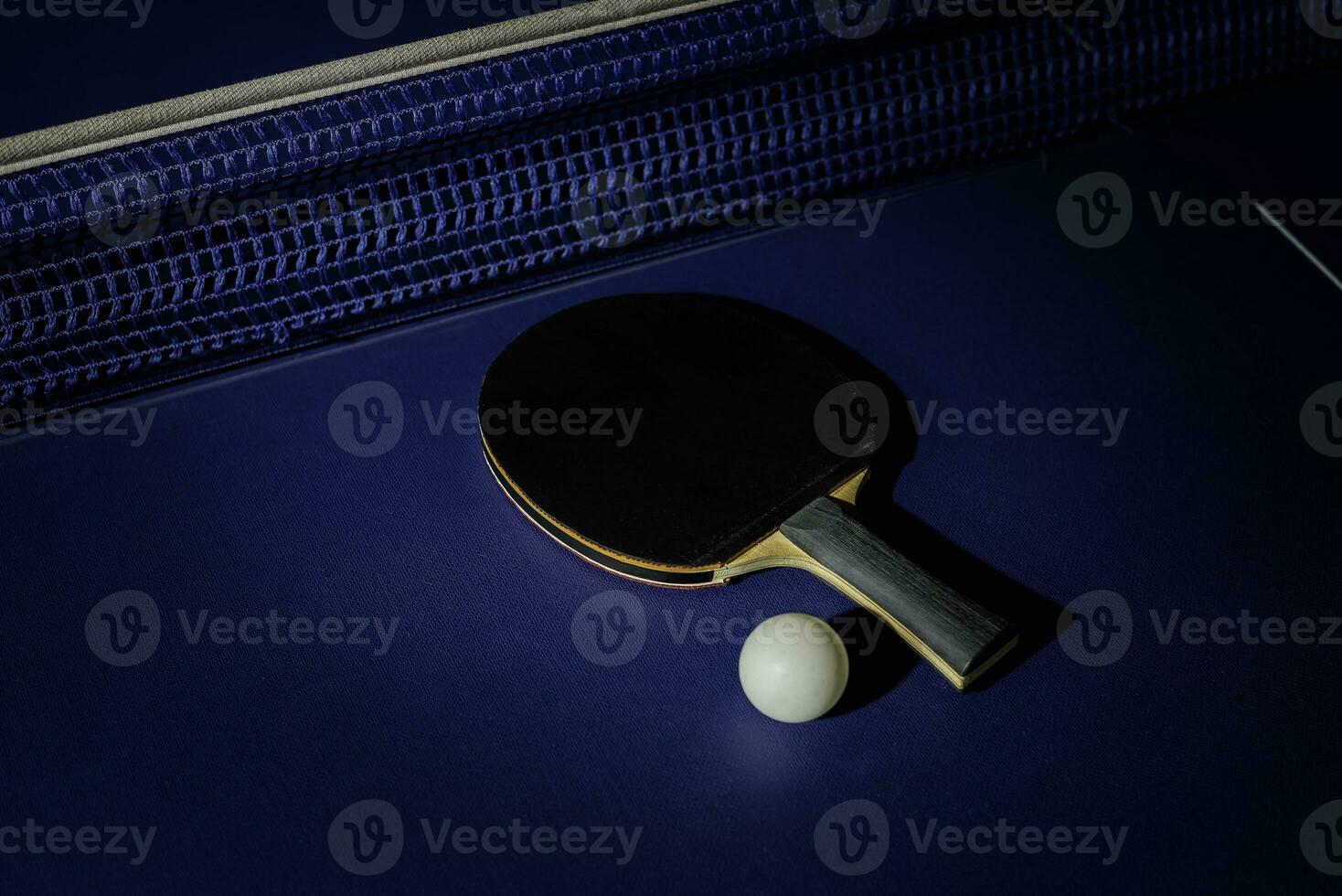 table tennis racket On the blue ping pong table photo