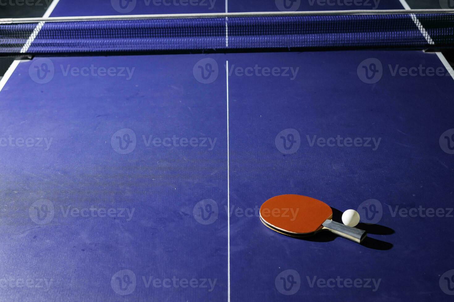 table tennis racket On the blue ping pong table photo