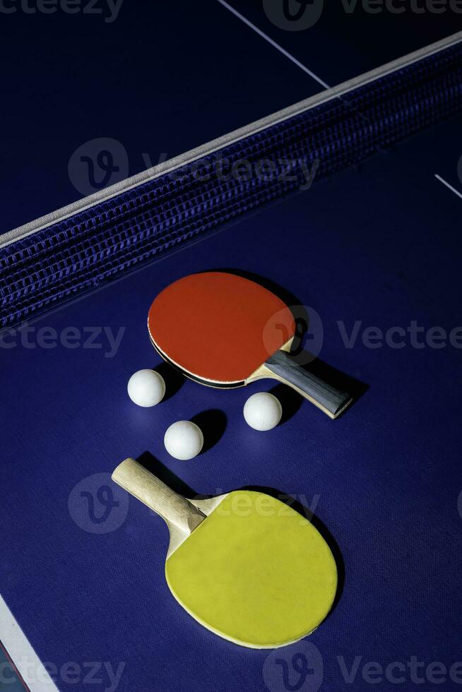 table tennis racket On the blue ping pong table photo