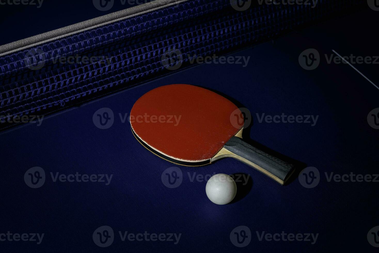 table tennis racket On the blue ping pong table photo