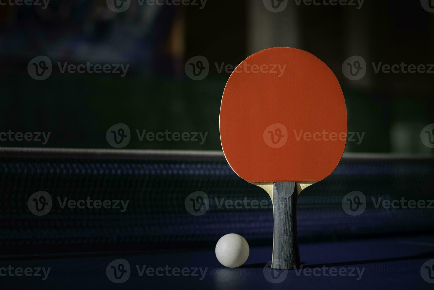 table tennis racket On the blue ping pong table photo