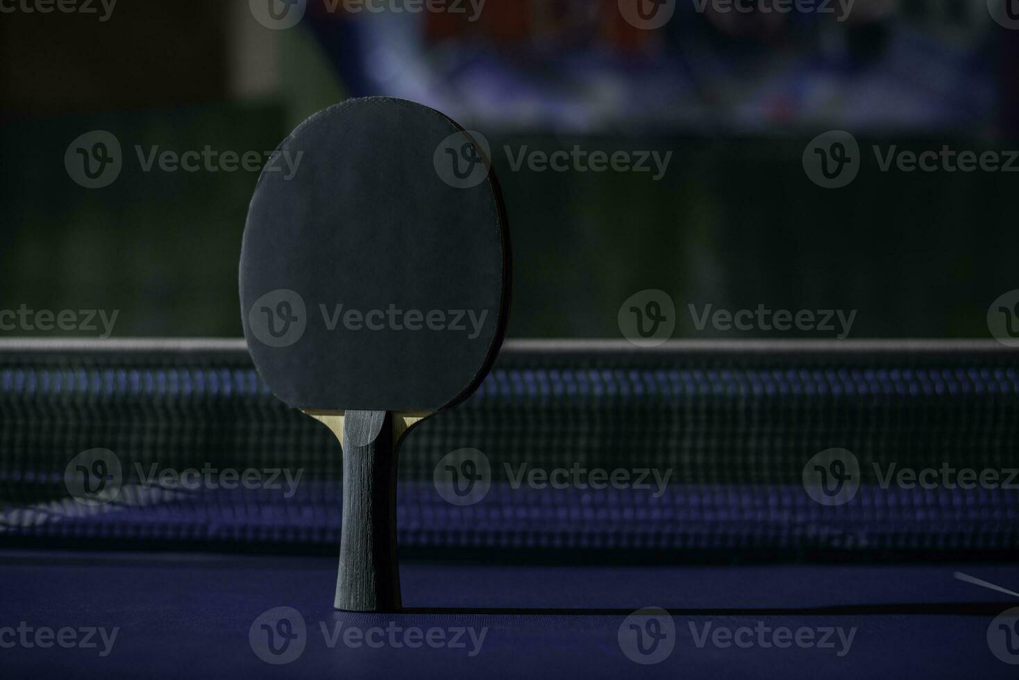 table tennis racket On the blue ping pong table photo
