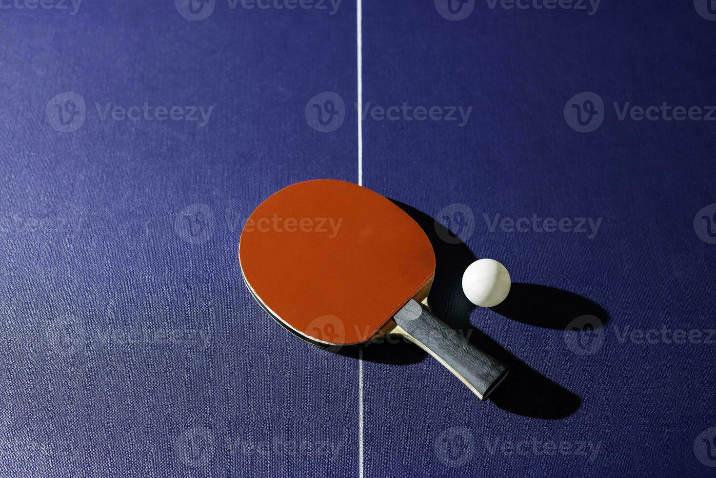 table tennis racket On the blue ping pong table photo