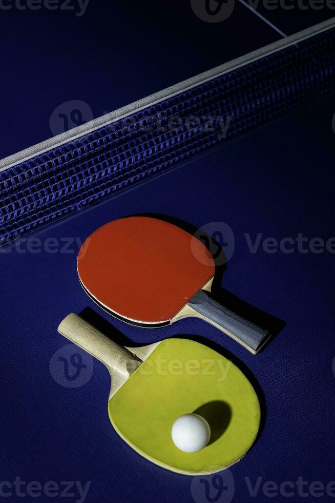 table tennis racket On the blue ping pong table photo