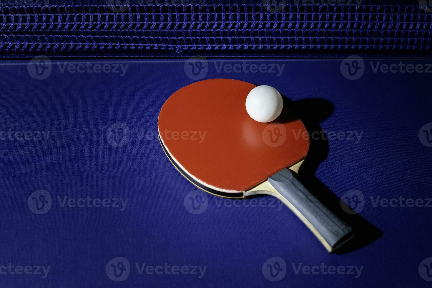 table tennis racket On the blue ping pong table photo