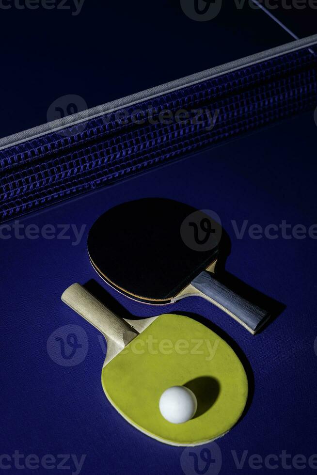 table tennis racket On the blue ping pong table photo