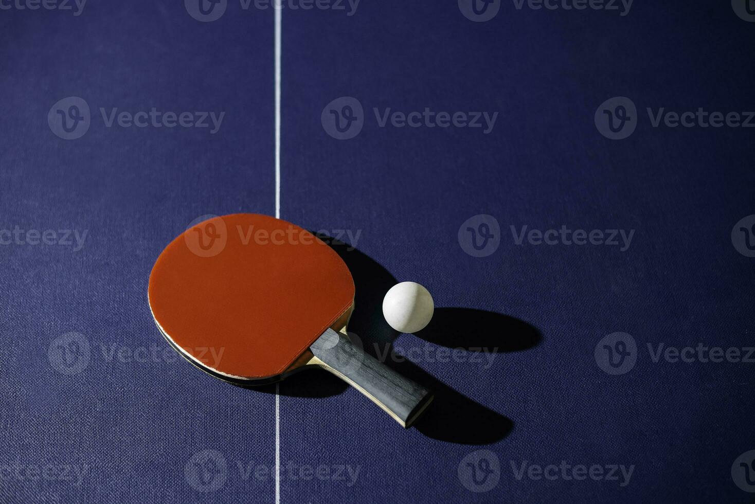 table tennis racket On the blue ping pong table photo