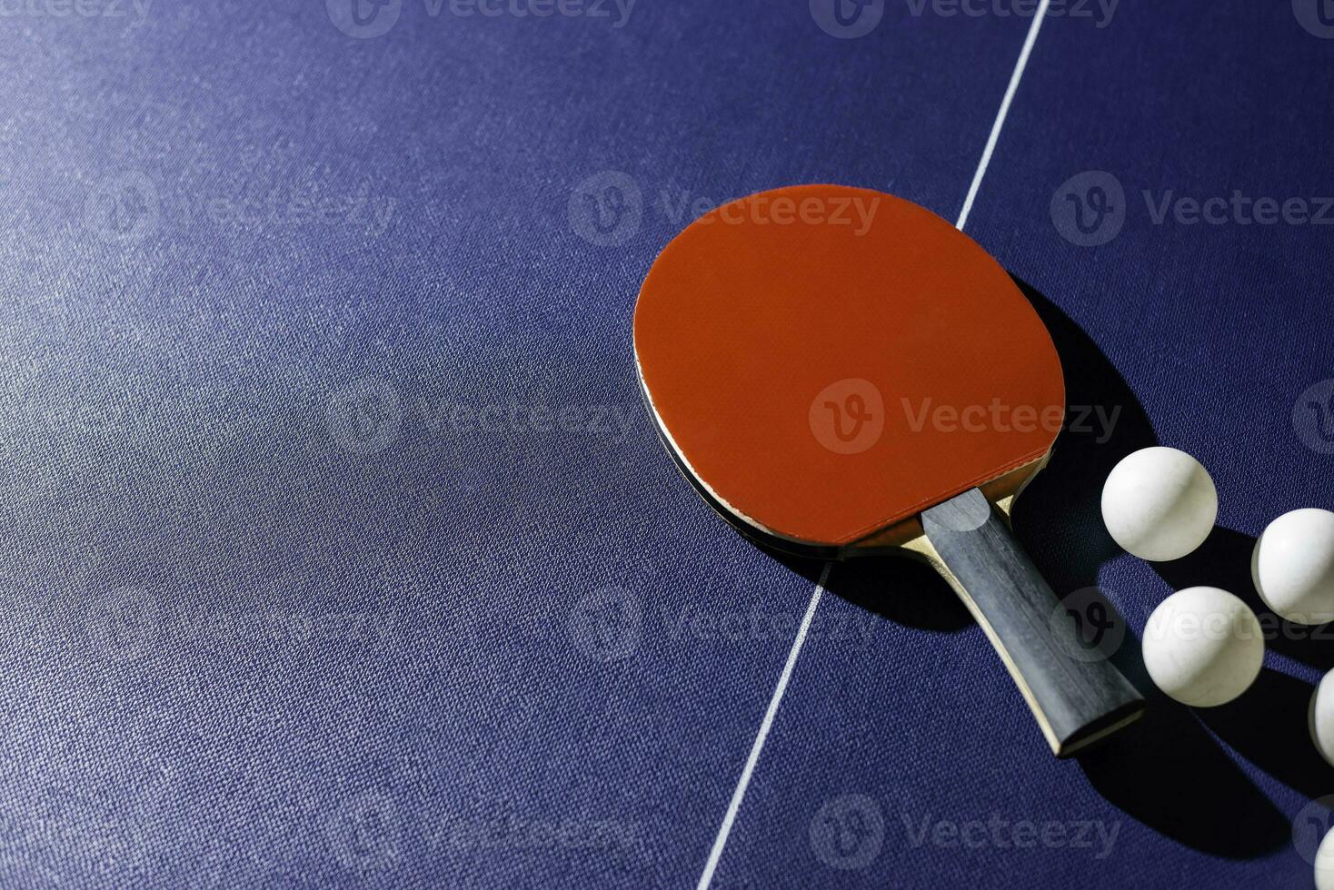 table tennis racket On the blue ping pong table photo