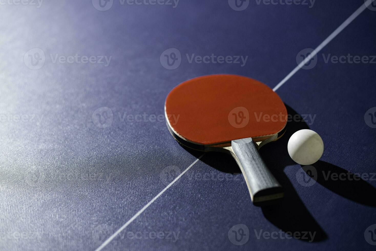 table tennis racket On the blue ping pong table photo