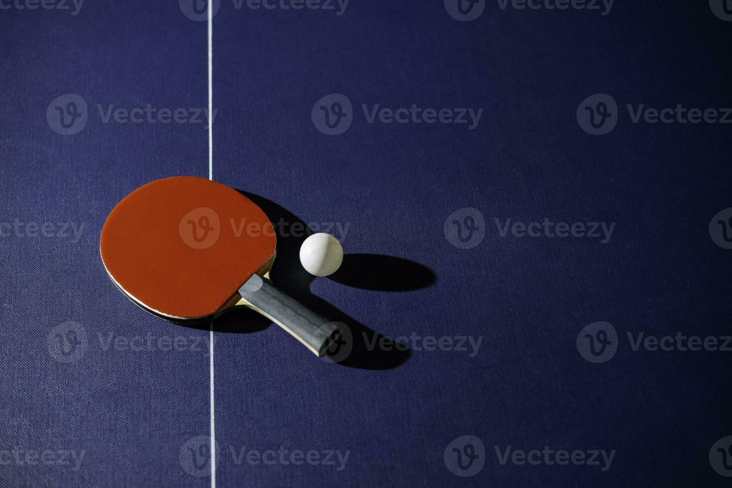 table tennis racket On the blue ping pong table photo