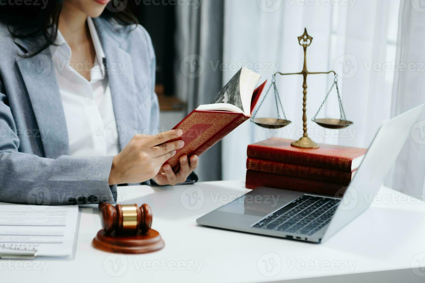 Woman lawyer reading legal book with gavel on table in office. justice and law ,attorney concept. photo
