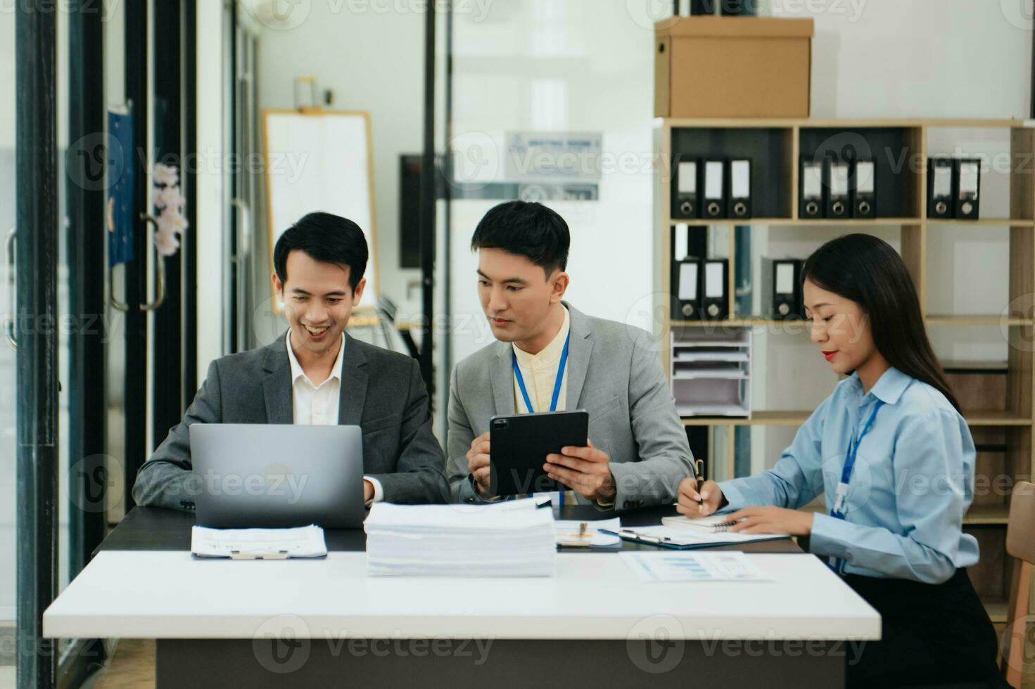 Office colleagues have a casual discussion. During a meeting in a conference room, a group of business teem sit in office room new startup project photo