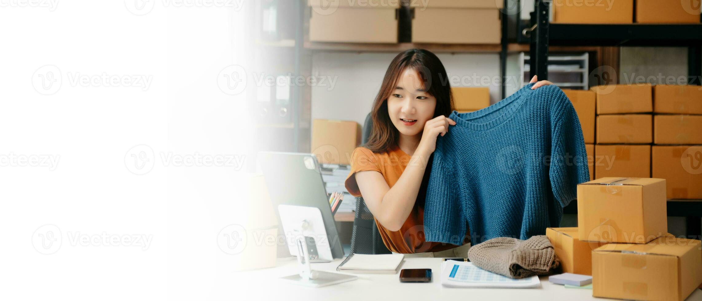 Asian lady blogger showing clothes in front of the camera to recording vlog video live photo