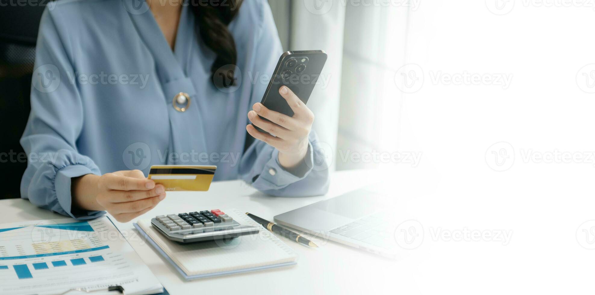 Woman using smart phone for mobile payments online shopping, omni channel, sitting on table, virtual icons graphics interface screen photo