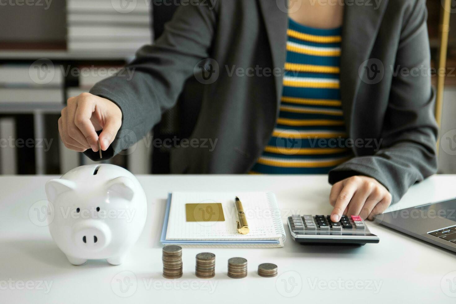 Business woman hand putting money coin into piggy bank with step of growing stack coins for saving money with virtual icon photo