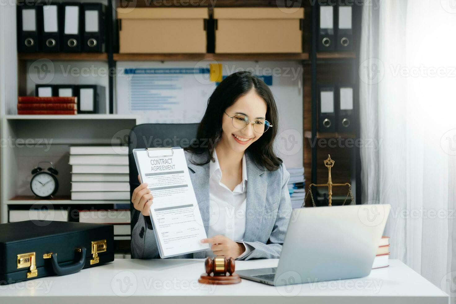 justice and law concept. Asian Female judge in a courtroom on wooden table and Counselor or Male lawyer working in modern office. photo