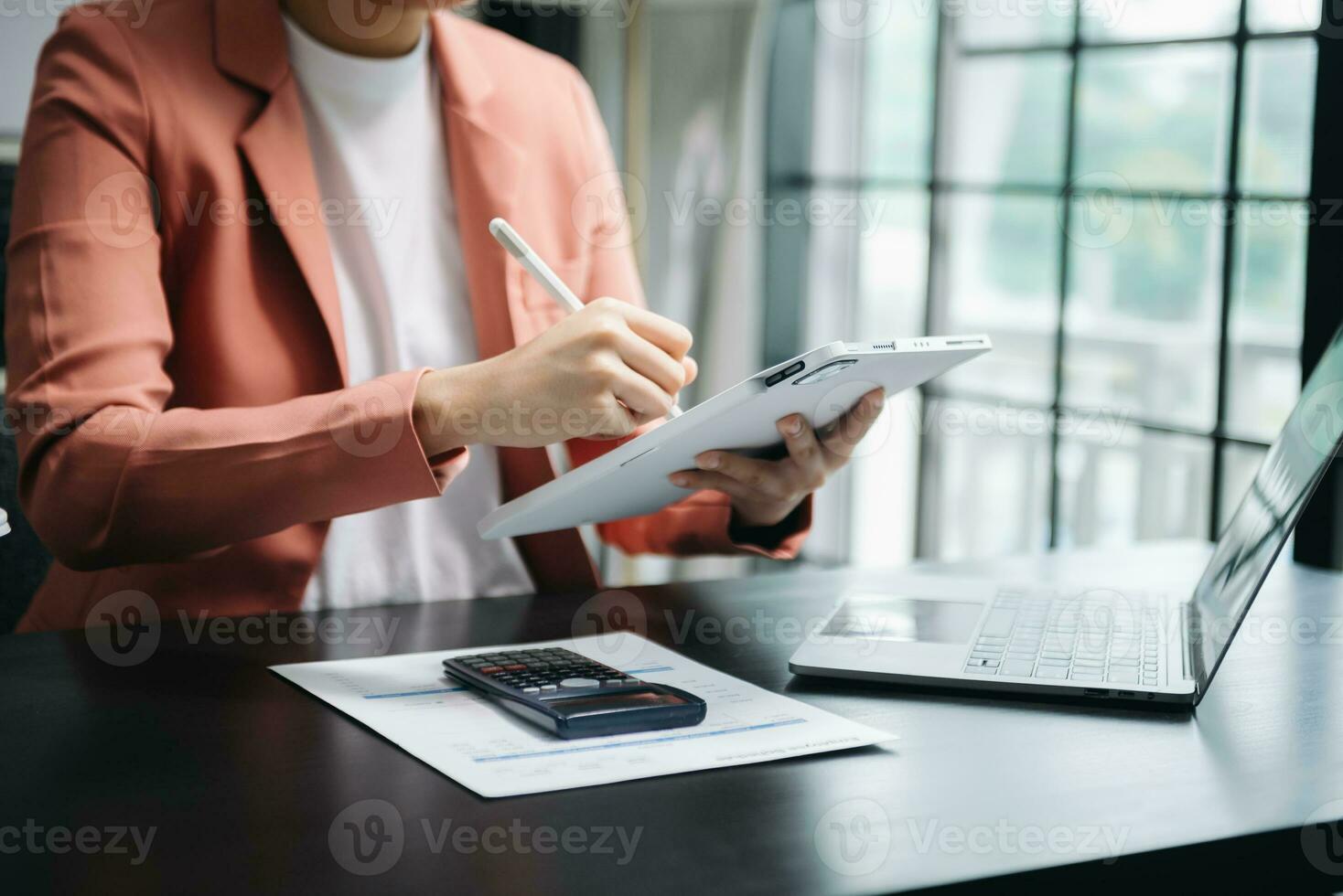 Businesswoman hand using laptop, tablet and smartphone in office. Digital marketing media mobile app and discussing plan new start up project. Finance task. photo