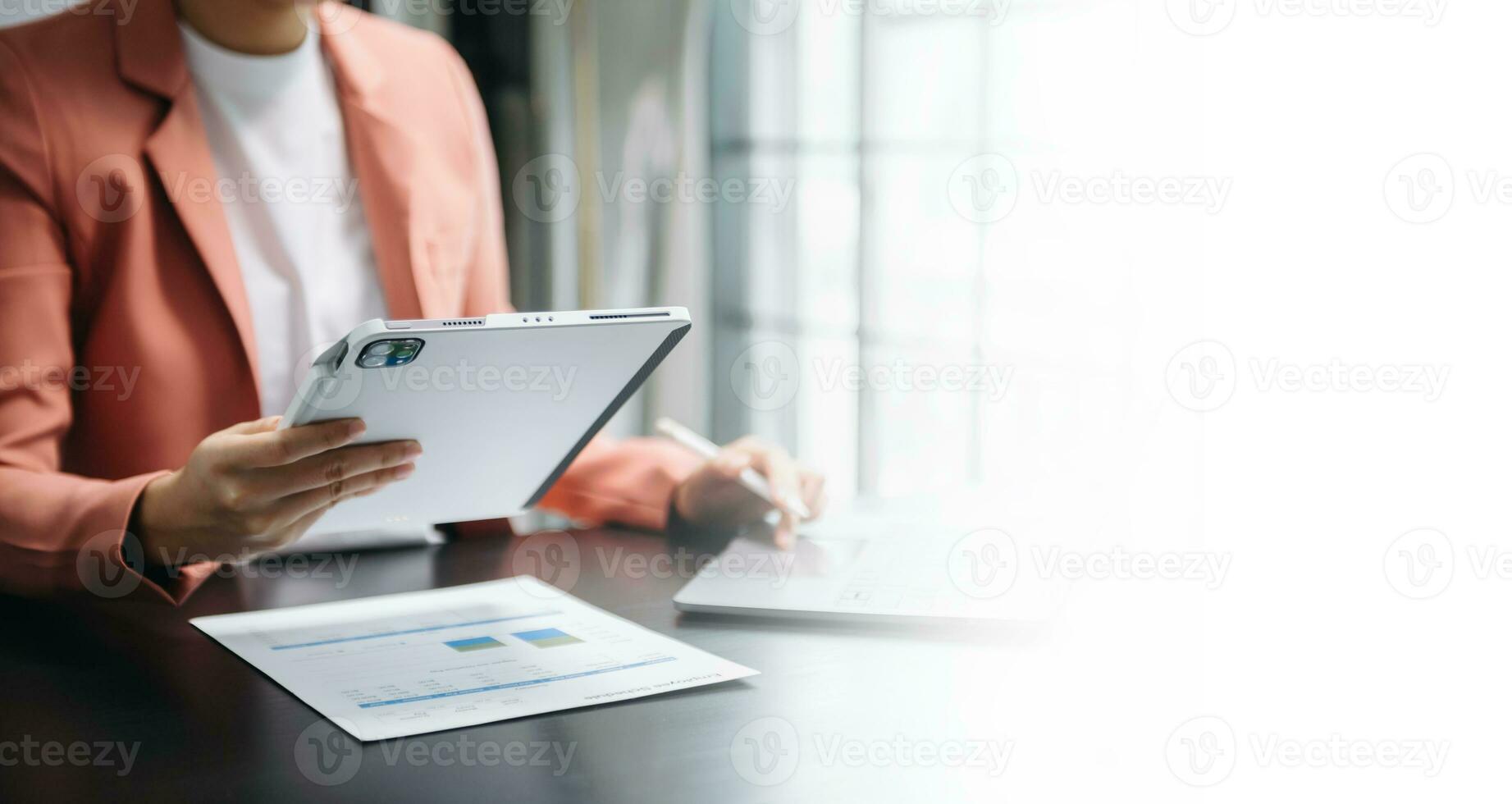 Businesswoman hand using laptop, tablet and smartphone in office. Digital marketing media mobile app and discussing plan new start up project. Finance task. photo