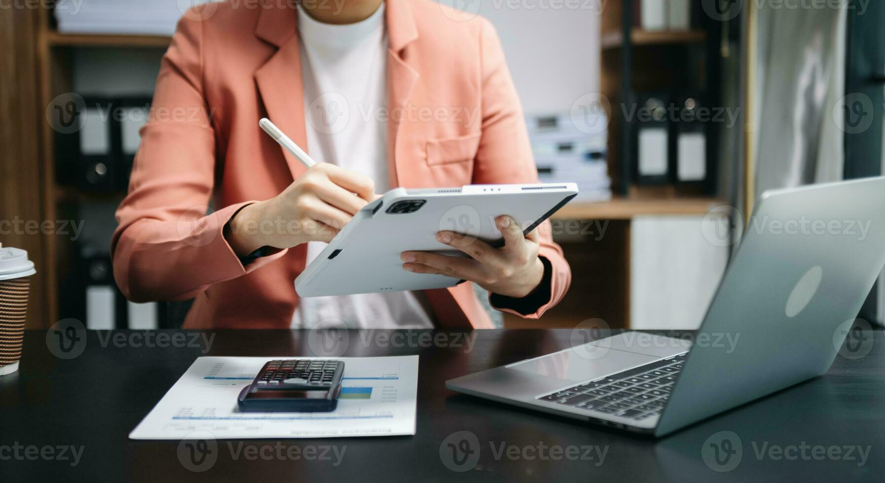 Businesswoman hand using laptop, tablet and smartphone in office. Digital marketing media mobile app and discussing plan new start up project. Finance task. photo