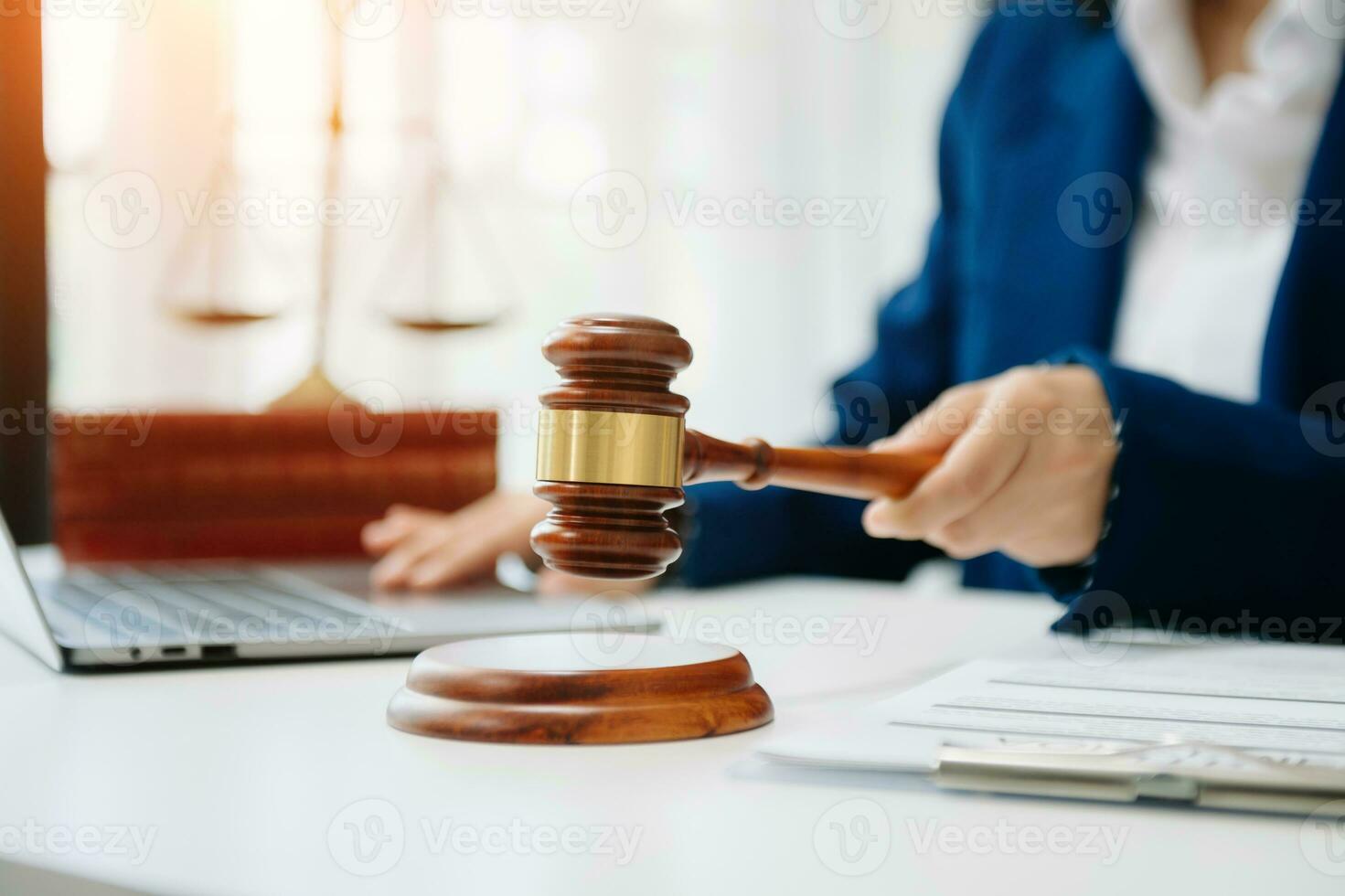 justice and law concept.law the desk, books, balance. Female judge in a courtroom the gavel,working with digital tablet computer photo