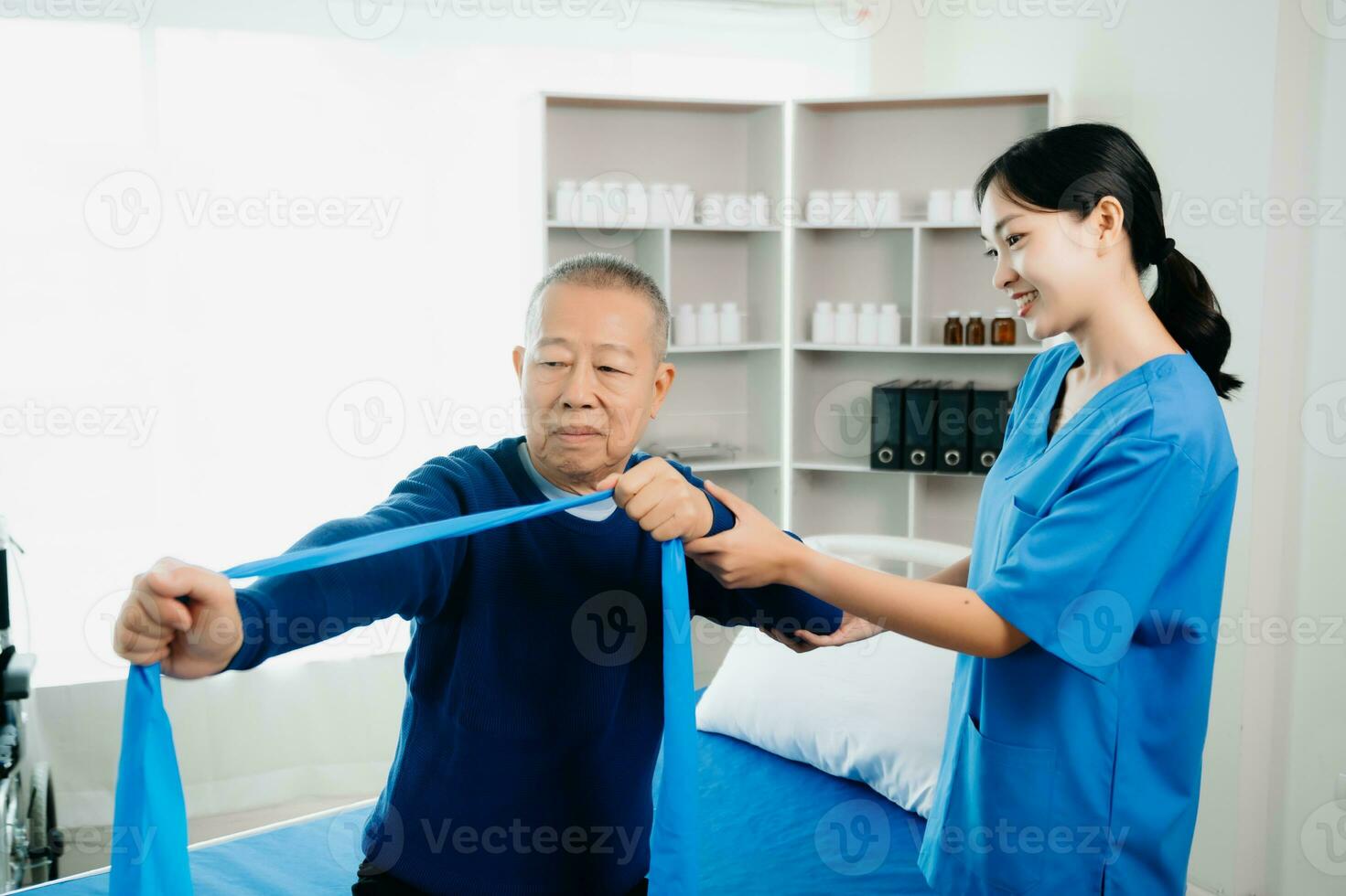 Asian physiotherapist helping elderly man patient stretching arm during exercise correct with dumbbell in hand during training hand with patient Back problems photo