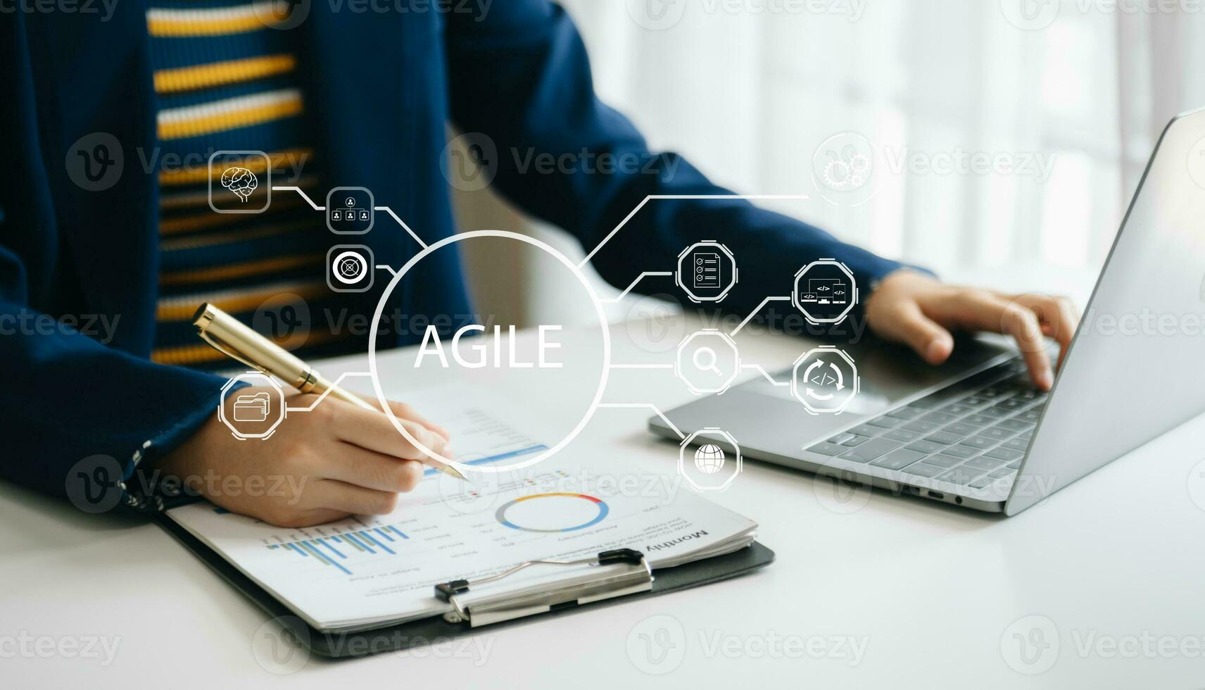 Agile development methodology concept. Business hand using laptop computer and tablet with virtual screen Agile icon on modern office photo