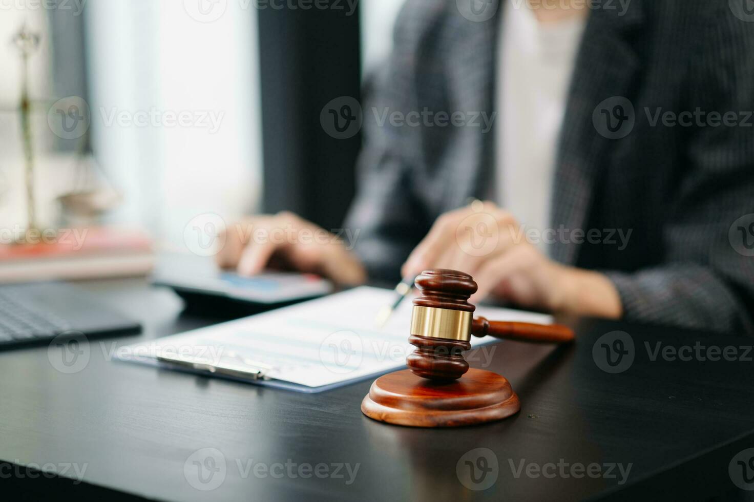 ustice and law concept.law the desk, books, balance. Male judge in a courtroom the gavel,working with digital tablet computer on table photo