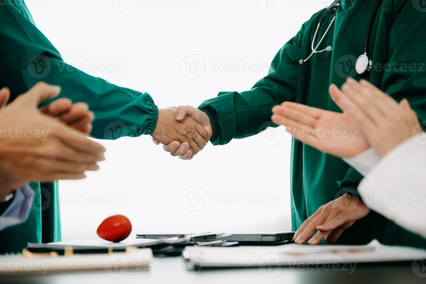 Doctor handshake and partnership in healthcare, medicine or trust for collaboration, unity or support.Team of medical experts shaking hands in teamwork for or success in clinic or hospital photo