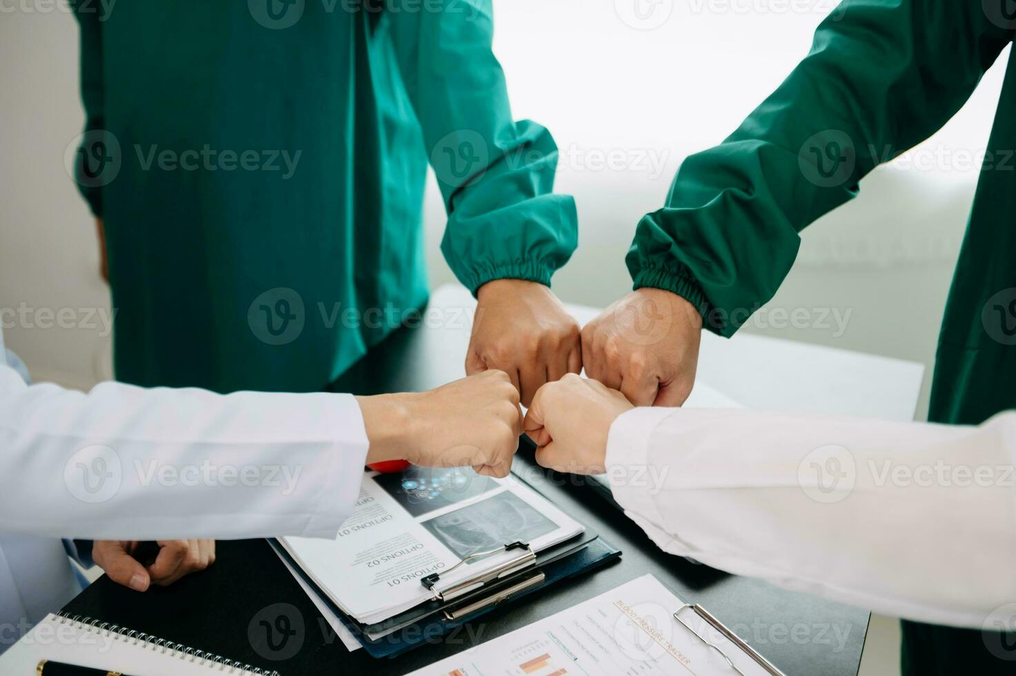 Doctor handshake and partnership in healthcare, medicine or trust for collaboration, unity or support.Team of medical experts shaking hands in teamwork for or success in clinic or hospital photo