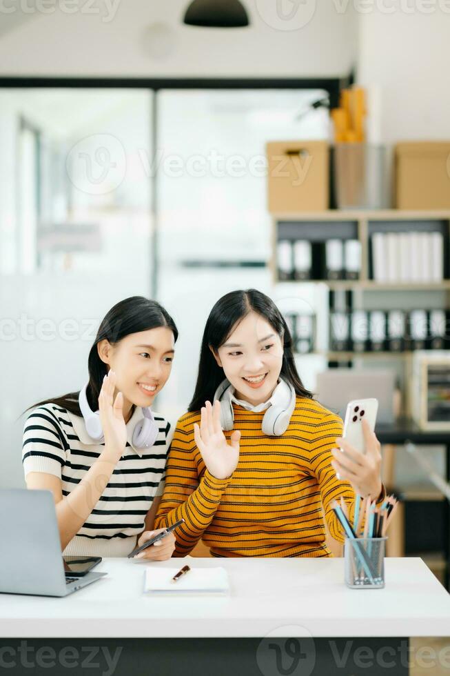 Asian Students are studying the campus park. Young people are spending time together. Reading book, working with laptop, tablet and communicating while in college library photo