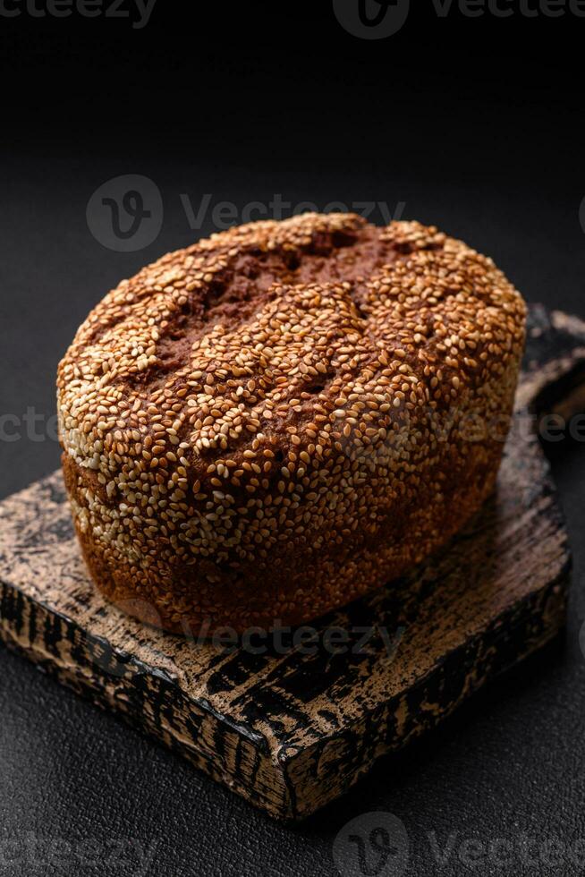 Delicious fresh crispy brown bread with seeds and grains photo