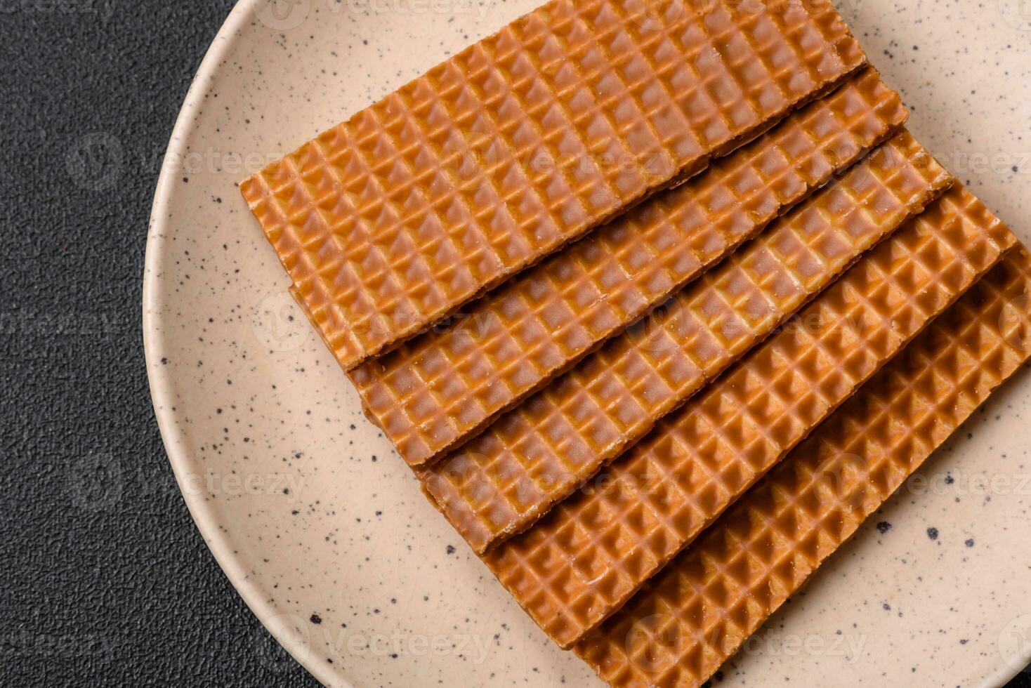 Delicious sweet crispy rectangular waffles on a ceramic plate photo