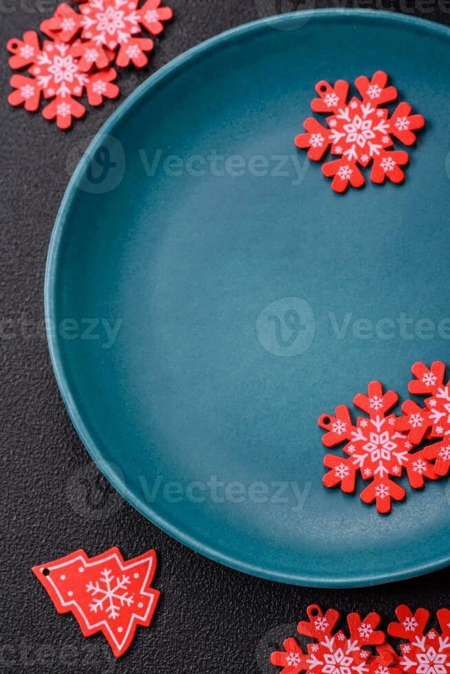 Ceramic round plate decorated with festive elements on the Christmas table photo