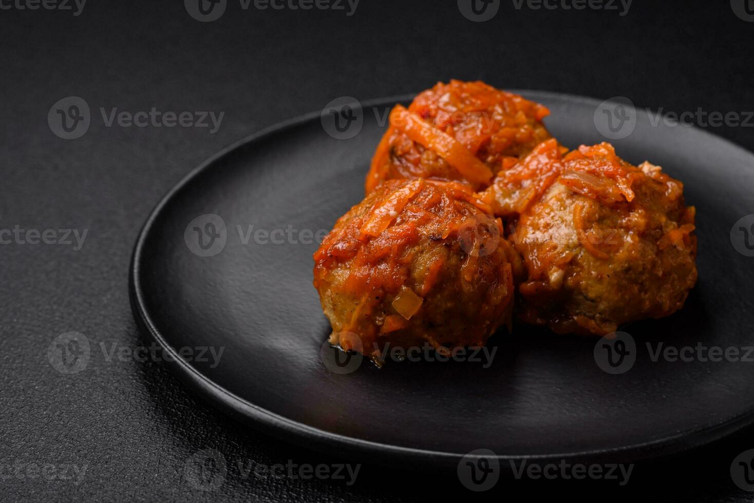 Delicious fresh meatballs from minced meat or fish with tomato sauce photo