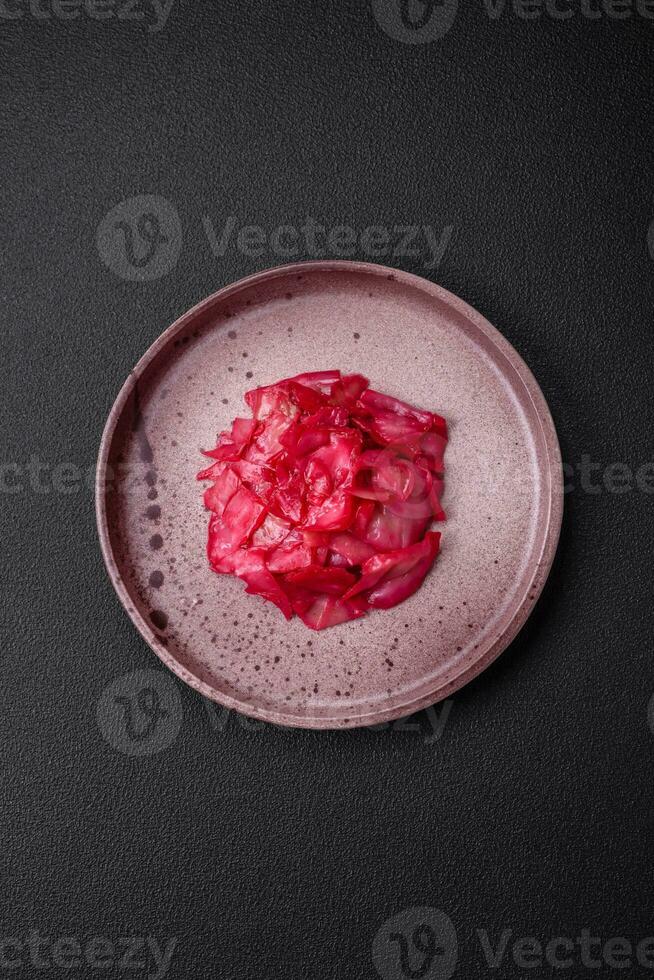 Delicious spicy pink cabbage sliced and cooked in Korean style on a ceramic plate photo