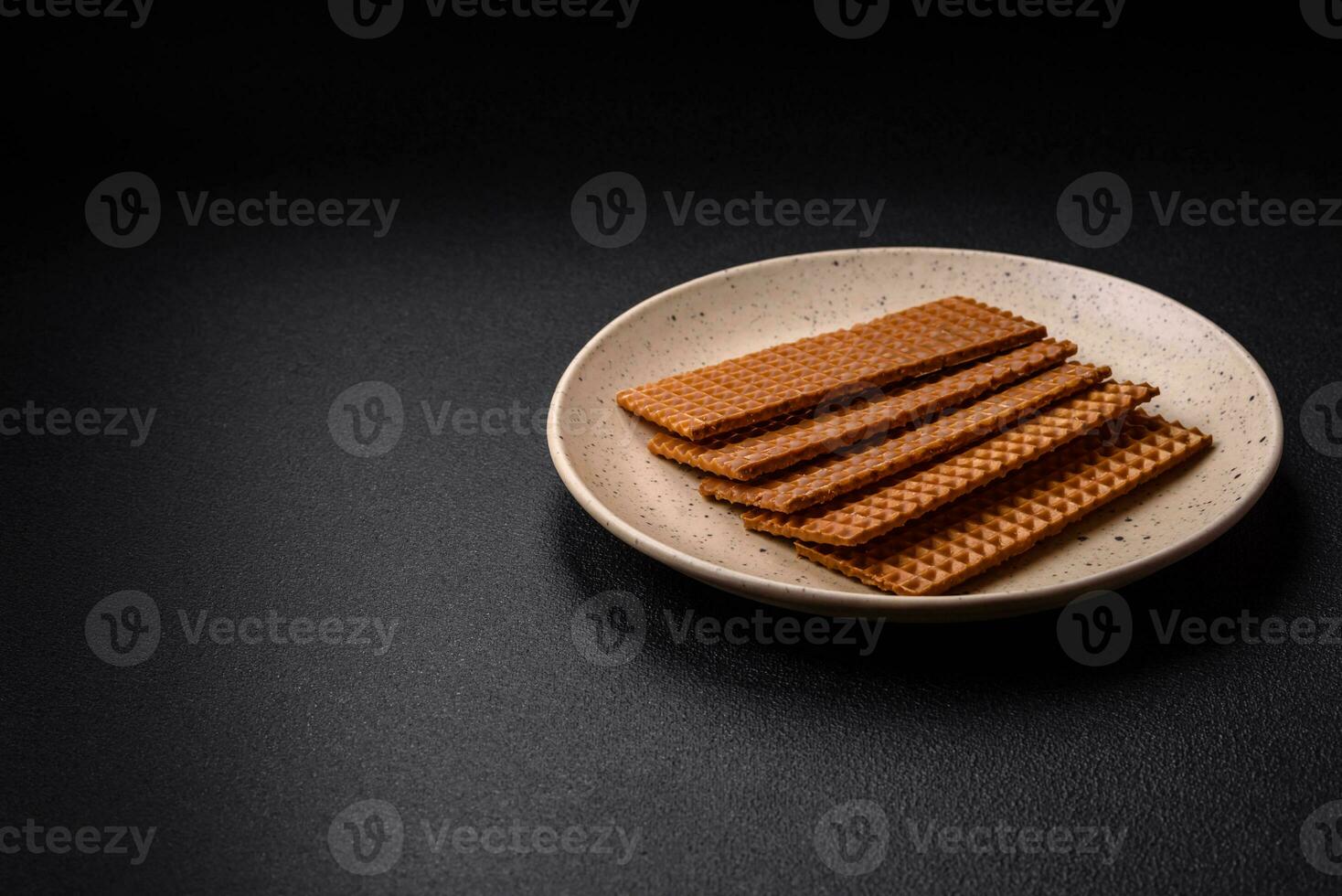 Delicious sweet crispy rectangular waffles on a ceramic plate photo