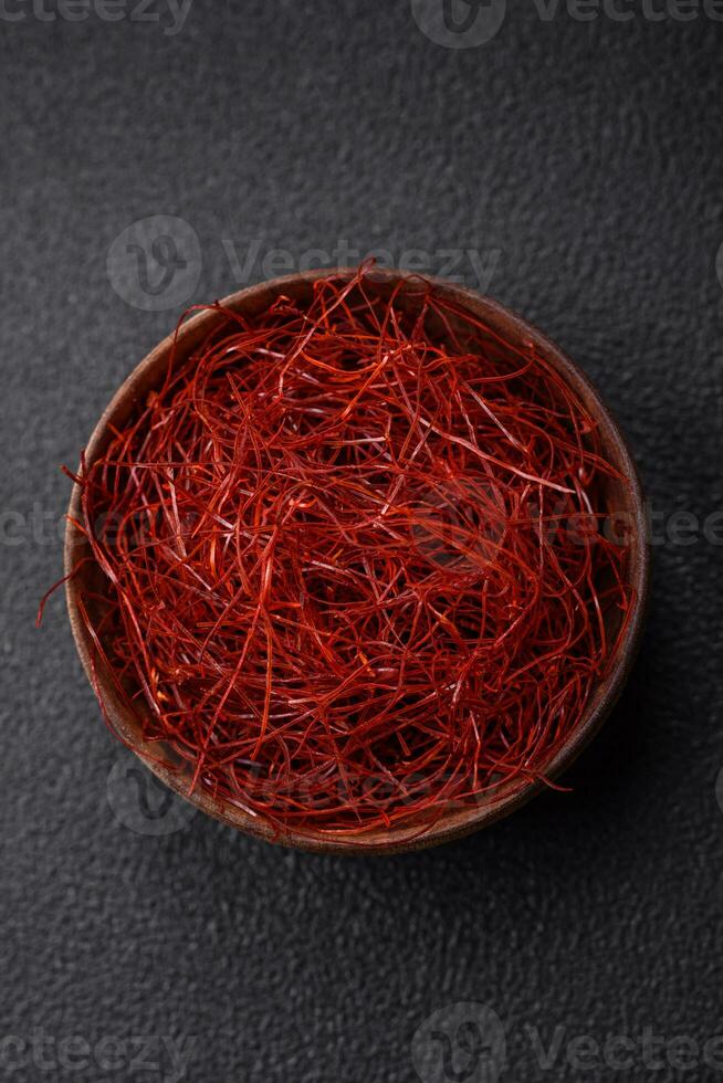 Red thin hot chili threads on a dark background photo