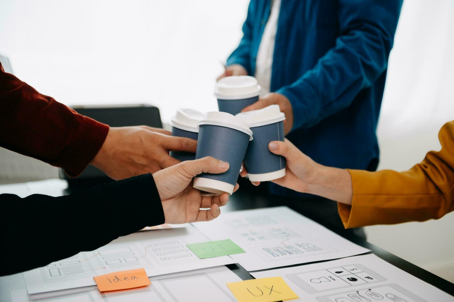 UX developer and ui designer brainstorming about mobile app interface wireframe design with customer breif and color code at modern office. photo