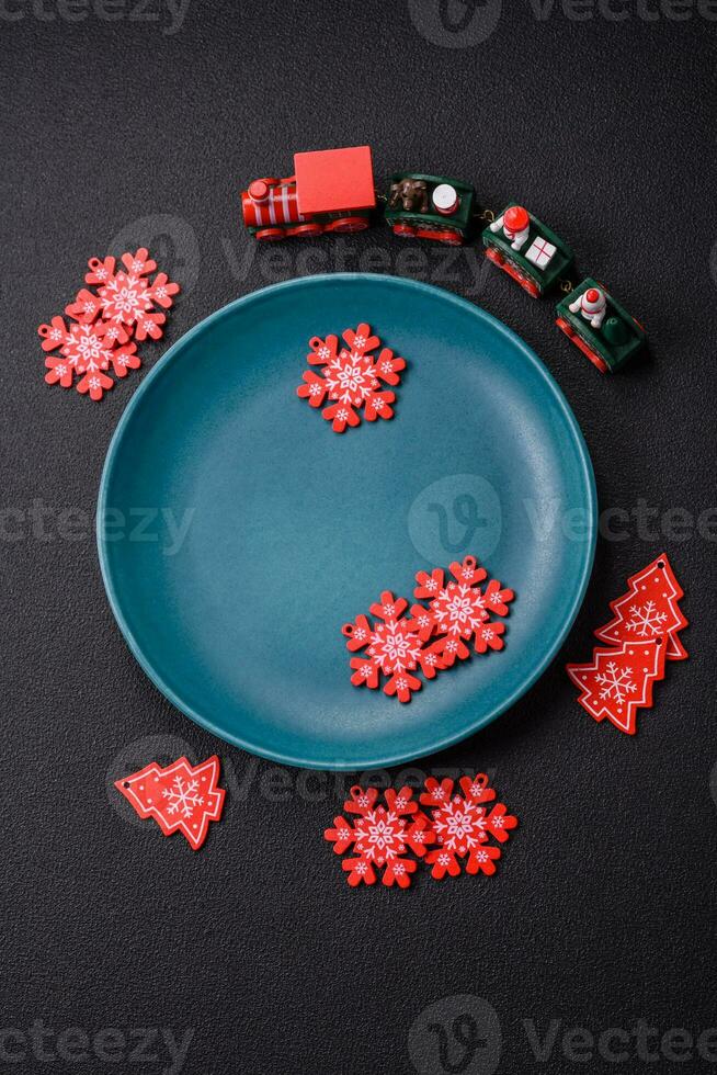 Ceramic round plate decorated with festive elements on the Christmas table photo