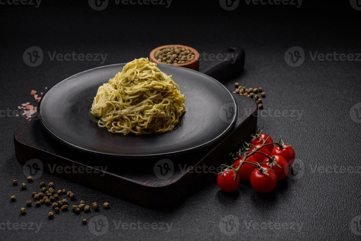 Capellini pasta or noodles with pesto sauce, salt and spices photo
