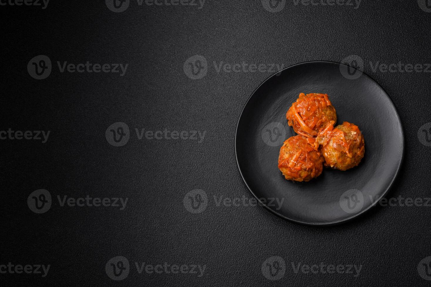 Delicious fresh meatballs from minced meat or fish with tomato sauce photo