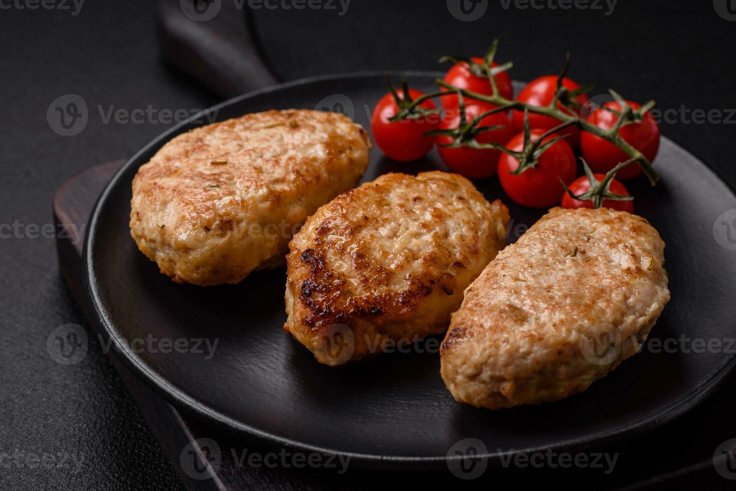 Delicious fresh chicken cutlets or meatballs with salt, spices and herbs photo