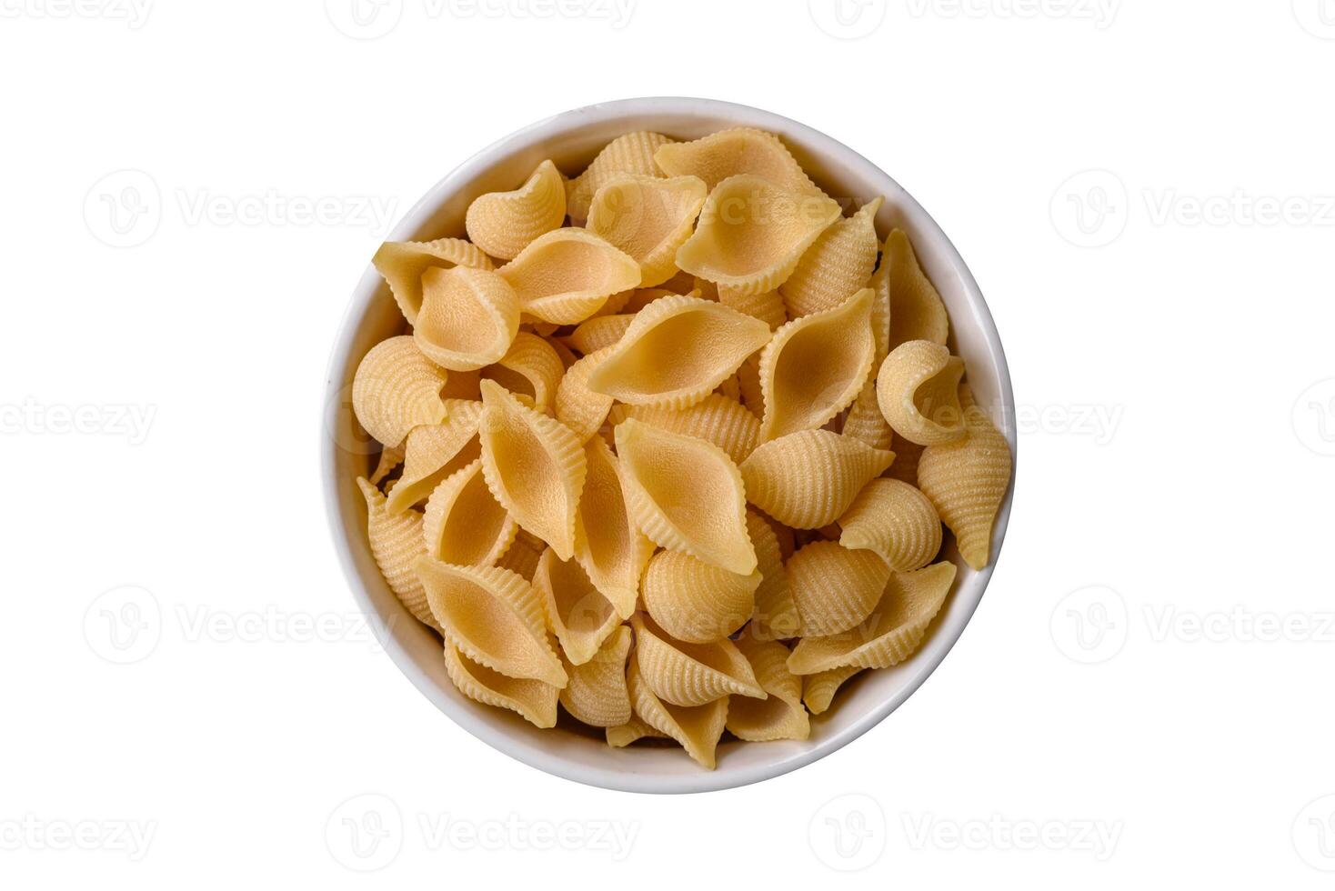 Raw Italian pasta conchiglie from durum wheat with vegetables, salt and spices photo