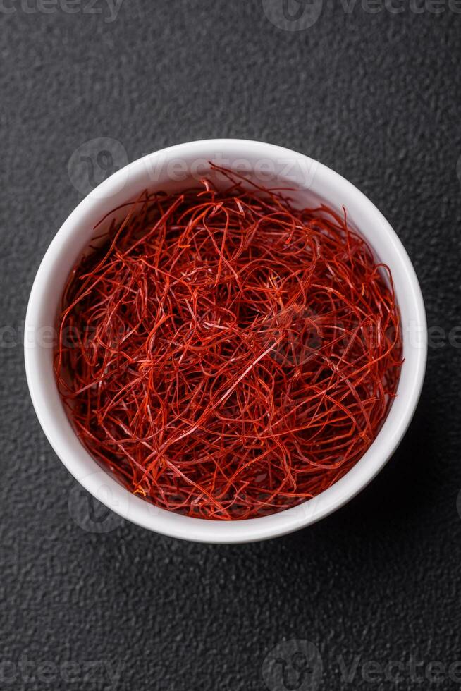 Red thin hot chili threads on a dark background photo