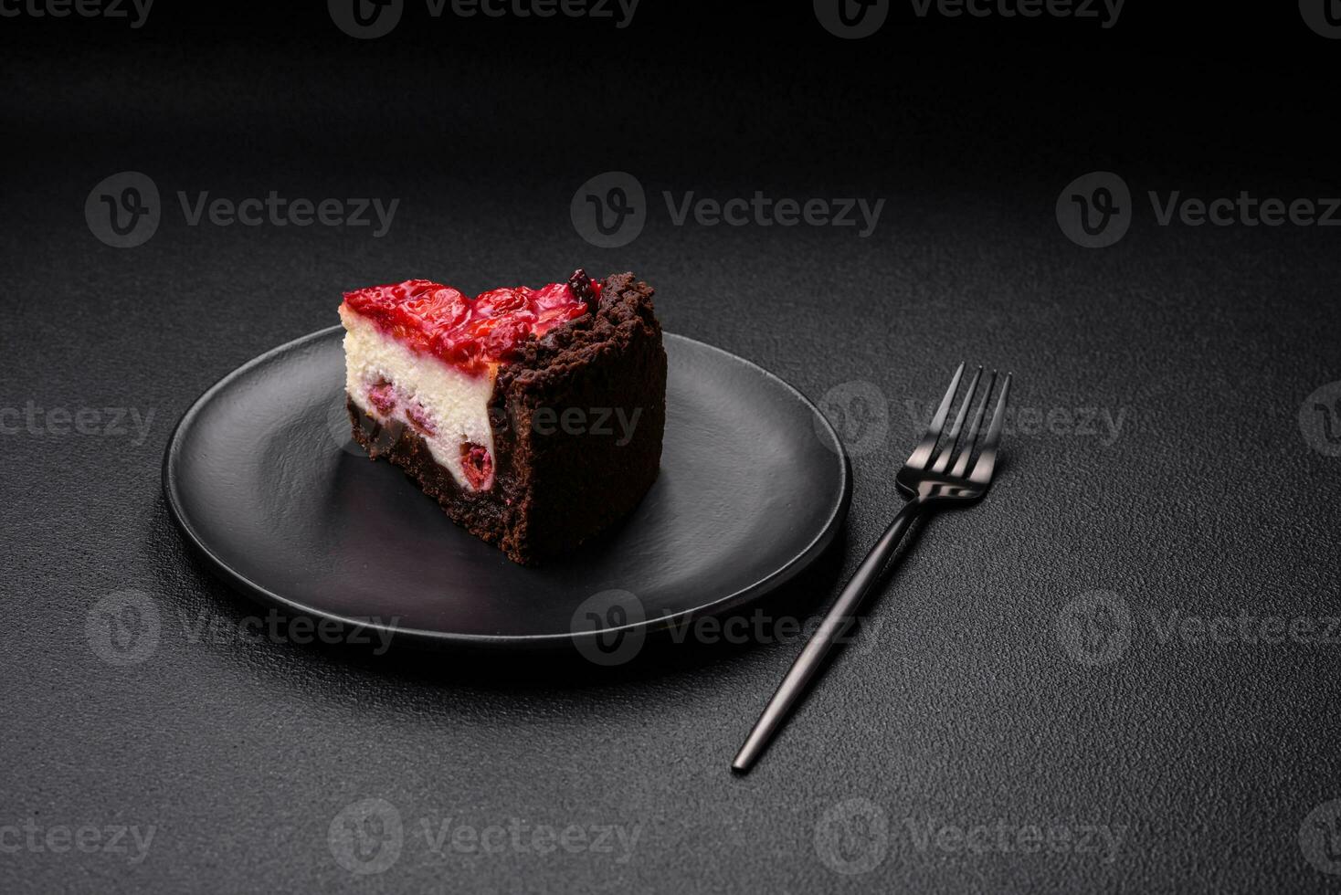 Beautiful tasty sweet slice of cheesecake with cherry on a ceramic plate photo