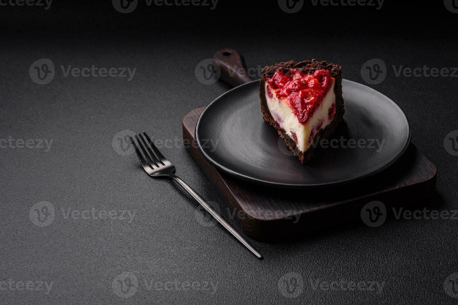 Beautiful tasty sweet slice of cheesecake with cherry on a ceramic plate photo