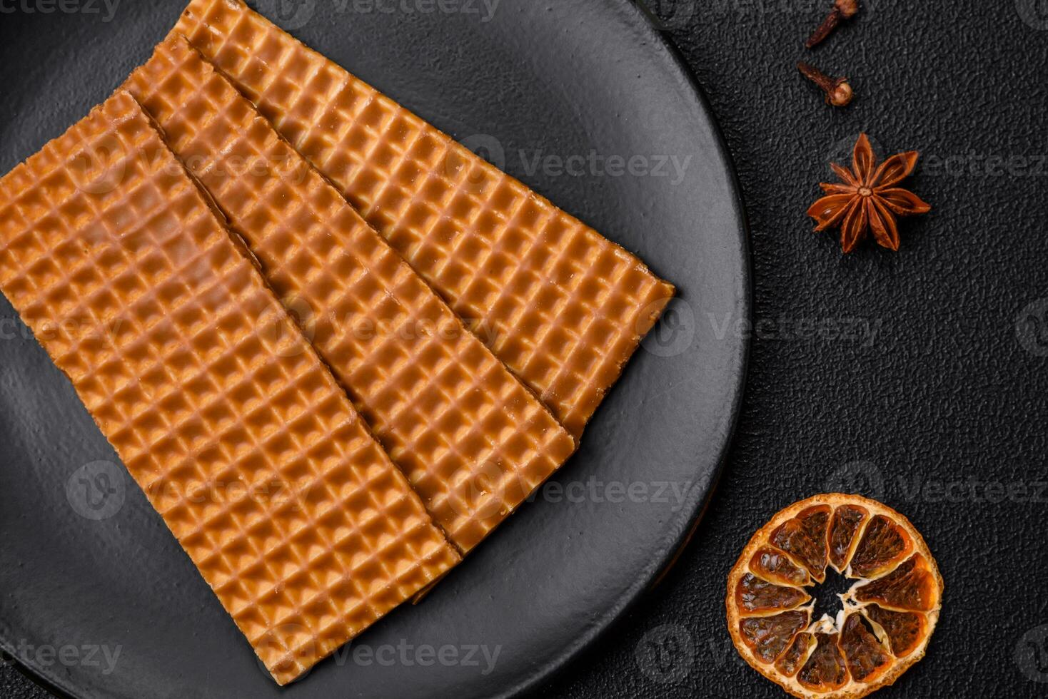 Delicious sweet crispy rectangular waffles on a ceramic plate photo