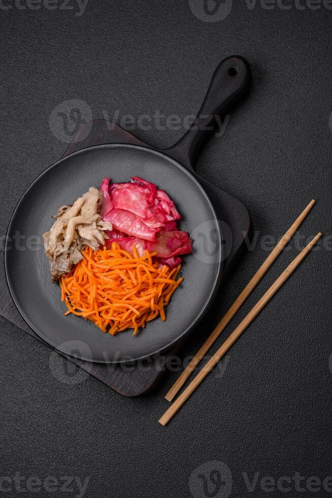 Delicious spicy mushrooms, carrots, cabbage sliced and cooked in Korean style photo